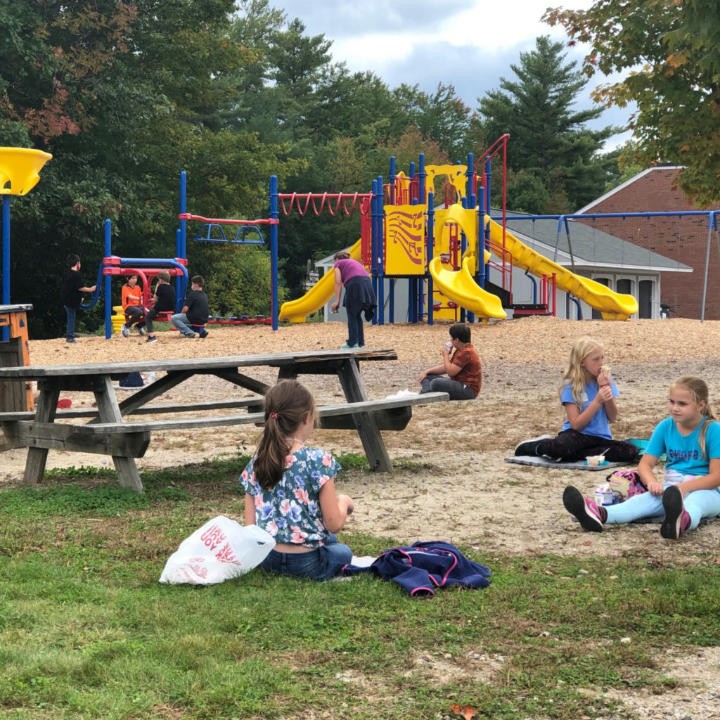 Featured image of article: AES students enjoying their lunch outside